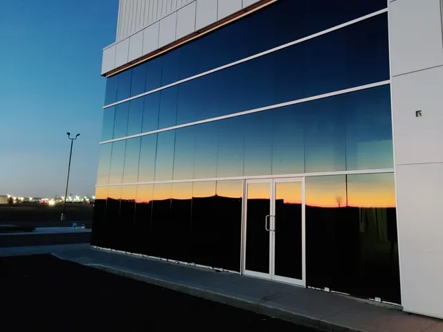 a building with a reflection of a sunset