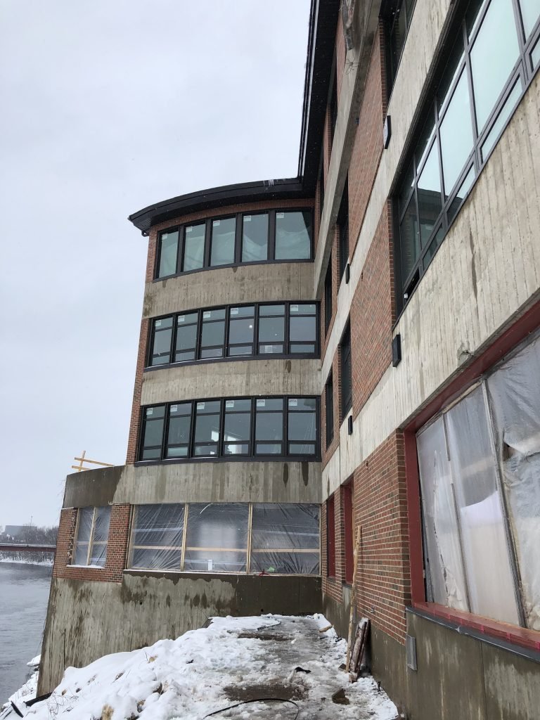 a building with windows and a body of water