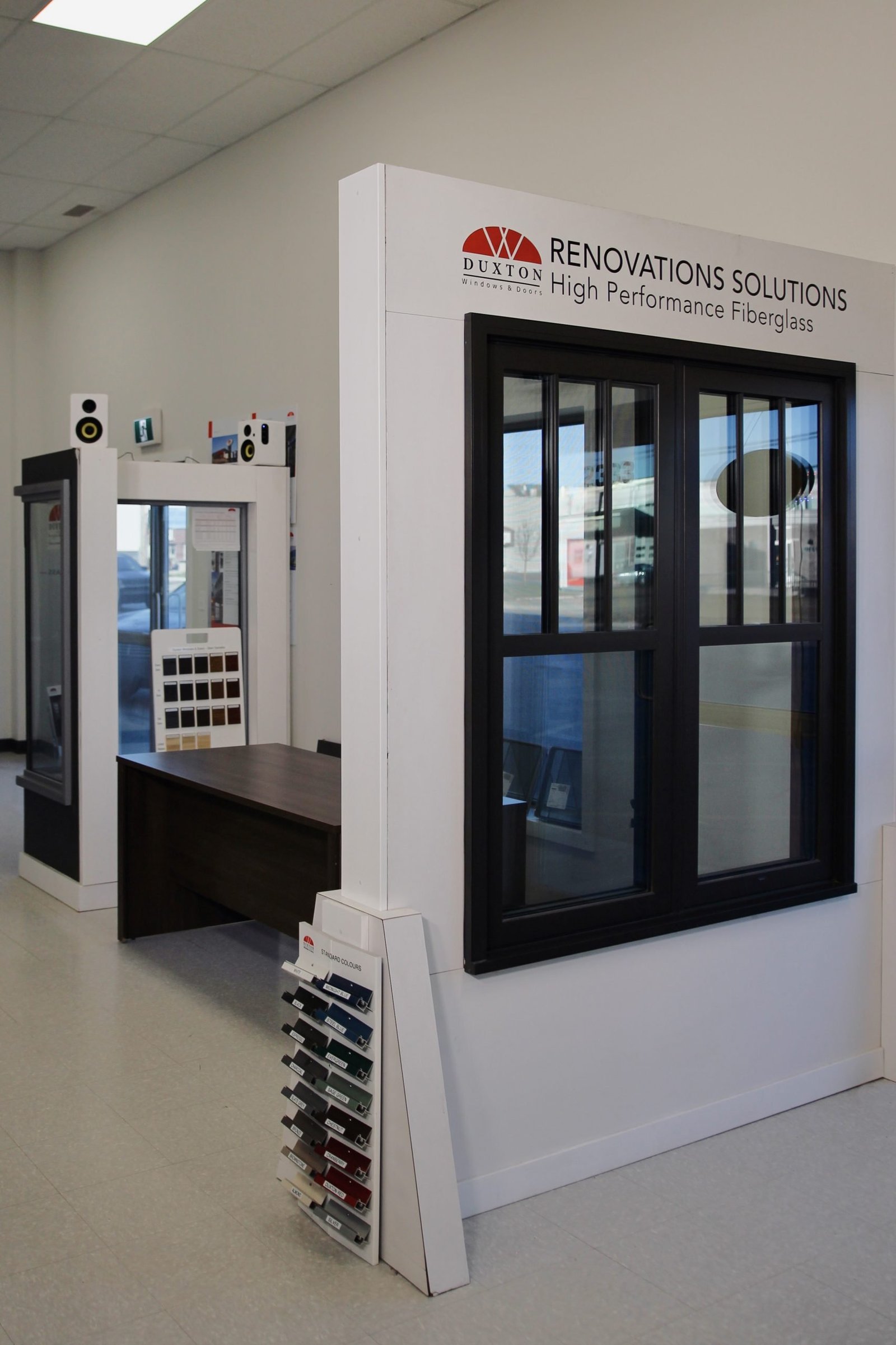 a white wall with black glass doors